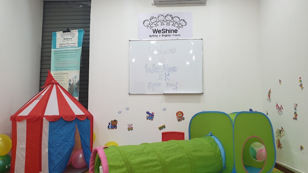 TTDI playroom with a tent, green play tunnel and WeShine sign