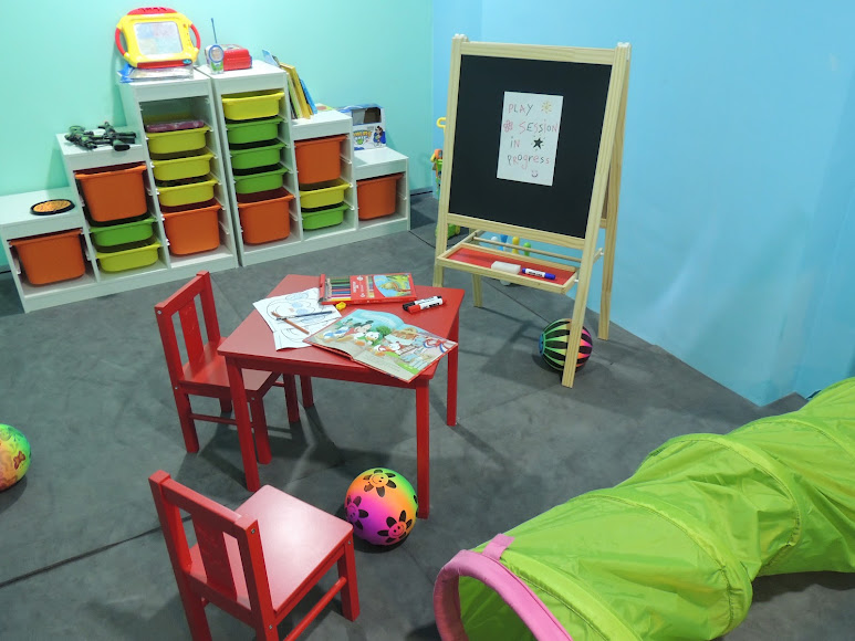 TTDI playroom with child-sized activity table, toy storage and green play tunnel